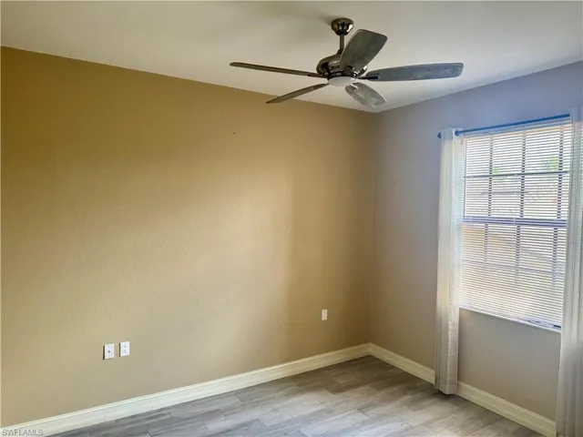 Spare room featuring ceiling fan and light wood-type flooring