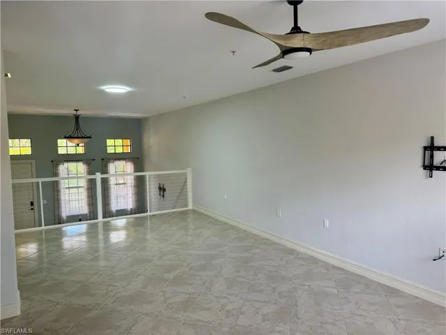 Unfurnished room featuring tile floors and ceiling fan