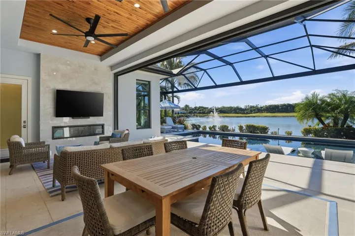 View of patio with glass enclosure, an outdoor hangout area, ceiling fan, a sunroom, and outdoor dining space