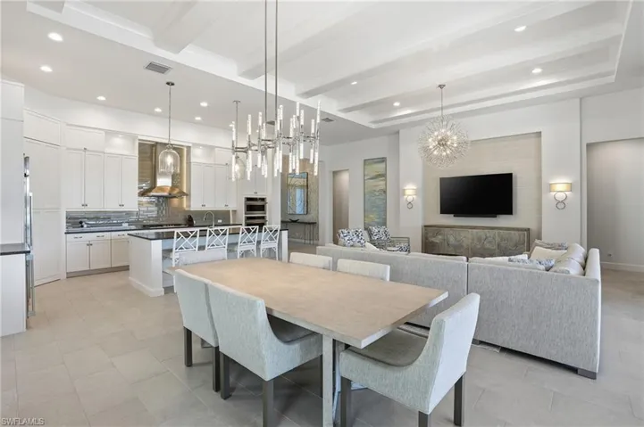 Dining area with a chandelier, recessed lighting, and beam ceiling