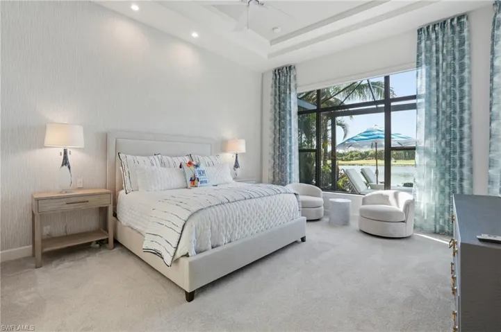 Bedroom with carpet, ceiling fan, a water view, and recessed lighting