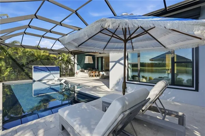 View of patio / terrace with a lanai, an outdoor pool, and a sunroom