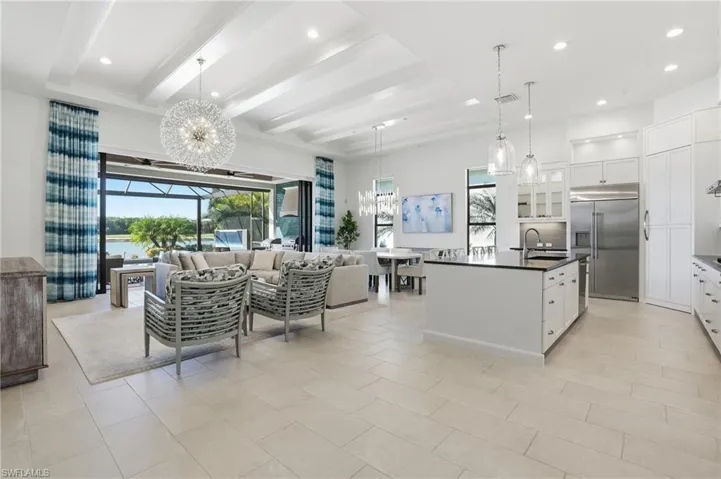 Kitchen featuring a chandelier, white cabinetry, recessed lighting, open floor plan, and decorative light fixtures
