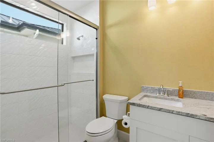 Full bath featuring vanity and a shower stall