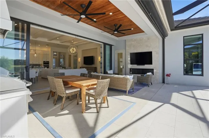 View of patio with outdoor dining space, an outdoor hangout area, and a ceiling fan