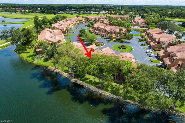 Aerial view of residential area featuring a nearby body of water