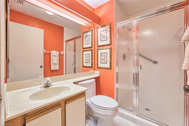 Full bathroom with vanity, a shower stall, and light tile patterned floors