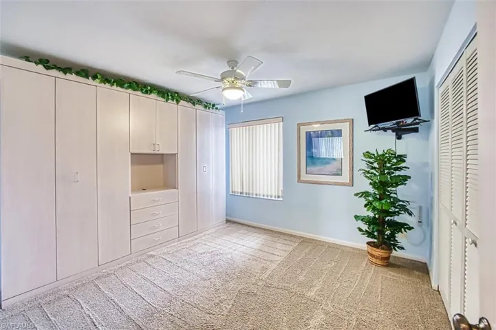 Unfurnished bedroom featuring a closet, light carpet, and ceiling fan