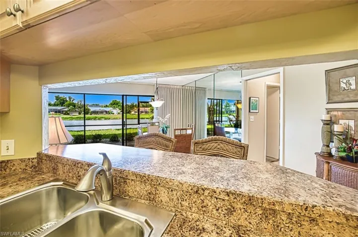 Kitchen featuring decorative light fixtures and a water view
