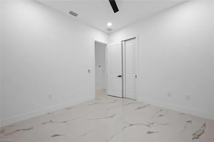 Spare room with a ceiling fan, recessed lighting, visible vents, and baseboards