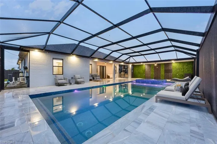 Outdoor pool featuring a patio, outdoor lounge area, and a lanai