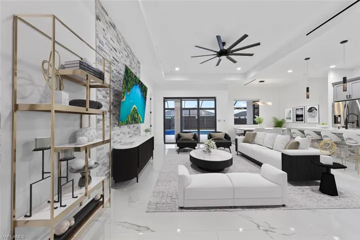 Virtual Staged-Living area with marble finish floor, a raised ceiling, a ceiling fan, and recessed lighting