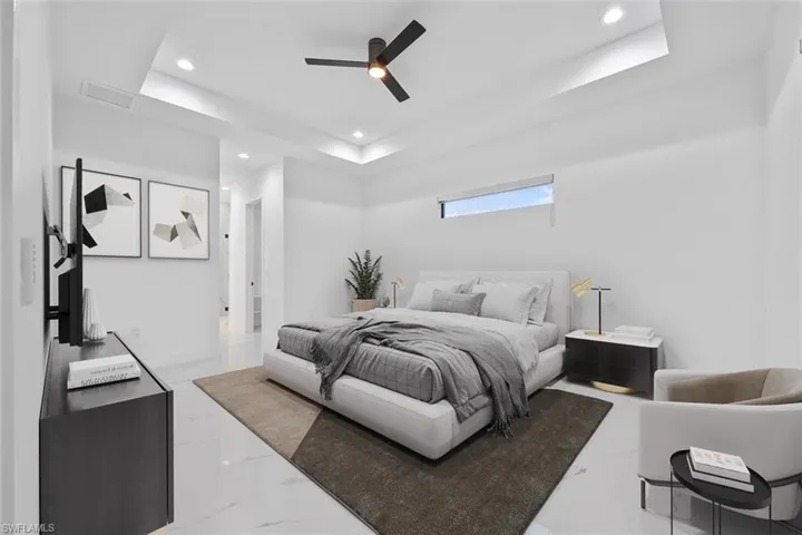 Virtually Staged- Bedroom with attic access, a raised ceiling, a ceiling fan, marble finish floor, and recessed lighting