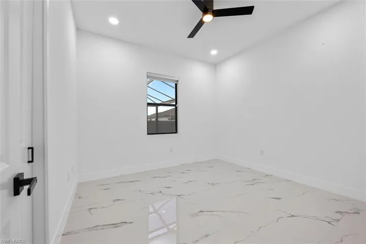 Unfurnished room with recessed lighting, marble finish floor, ceiling fan, and baseboards
