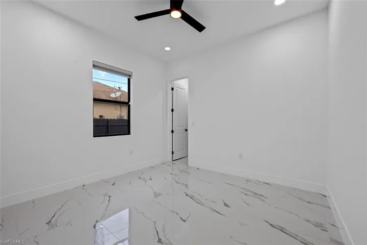 Spare room with ceiling fan, marble finish floor, recessed lighting, and baseboards