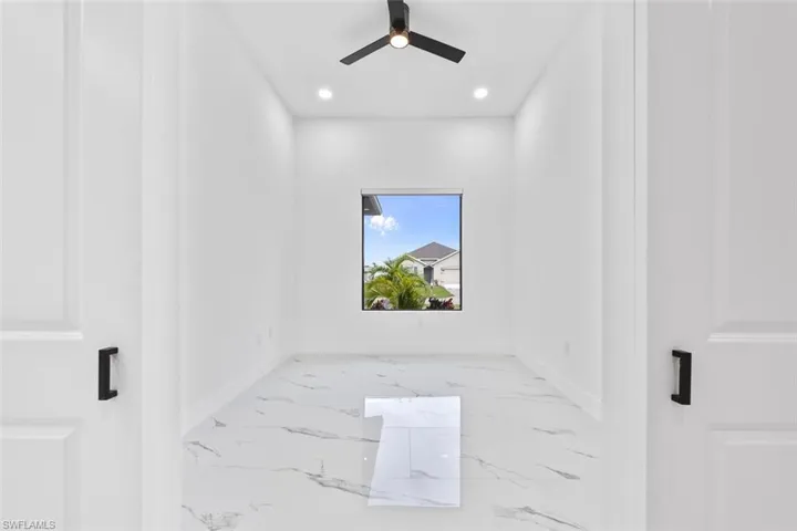 Unfurnished room with recessed lighting, marble finish floor, ceiling fan, and baseboards