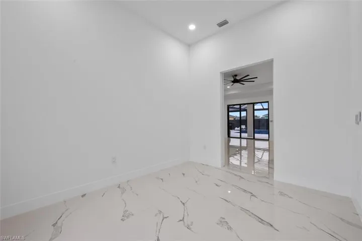 Spare room with marble finish floor, recessed lighting, visible vents, a ceiling fan, and baseboards