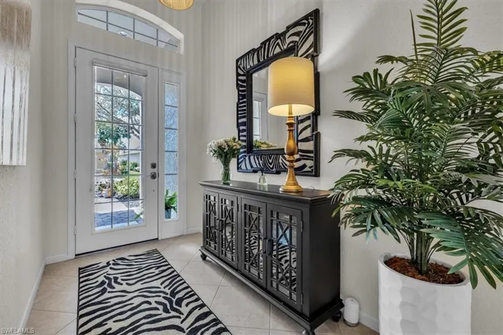 White paneled entry door with sidelight and transom window