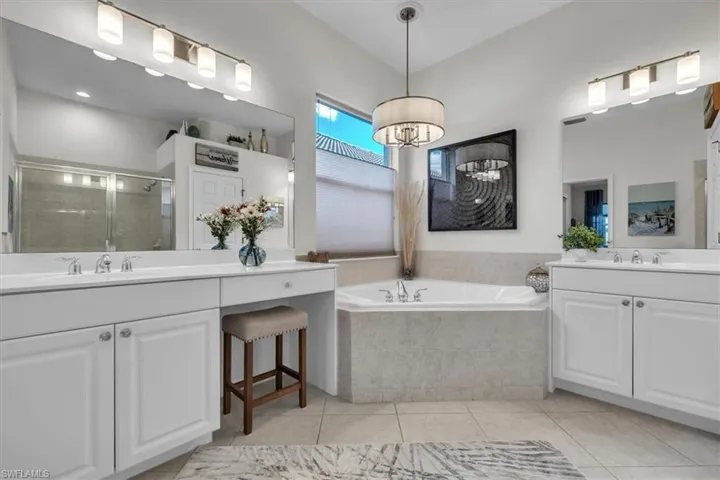 Dual vanity with undermount sinks, white cabinetry, and brushed nickel hardware