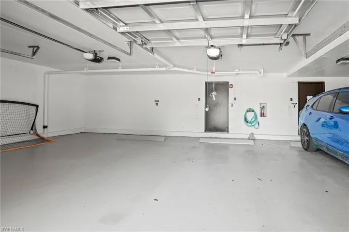 Single-bay secured garage with door and secured private storage locker.