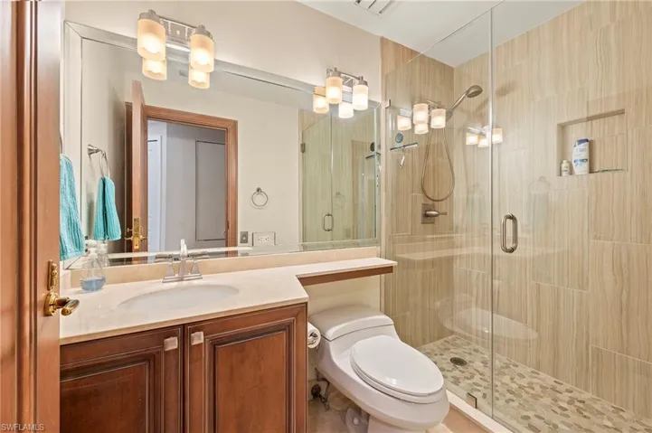Guest Bathroom with an enclosed shower and vanity.