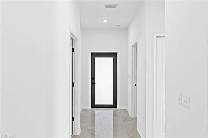 Corridor with light marble finish flooring and baseboards