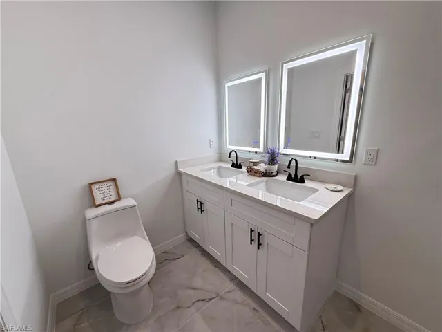 Bathroom with marble look tiles and double vanity