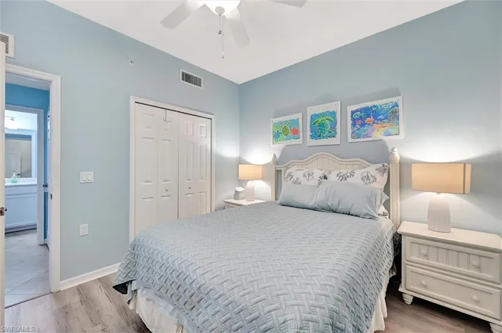 Bedroom with light wood-style floors, a closet, and ceiling fan