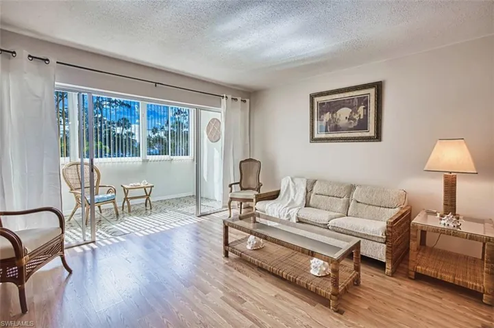 Living area with a textured ceiling and wood finished floors