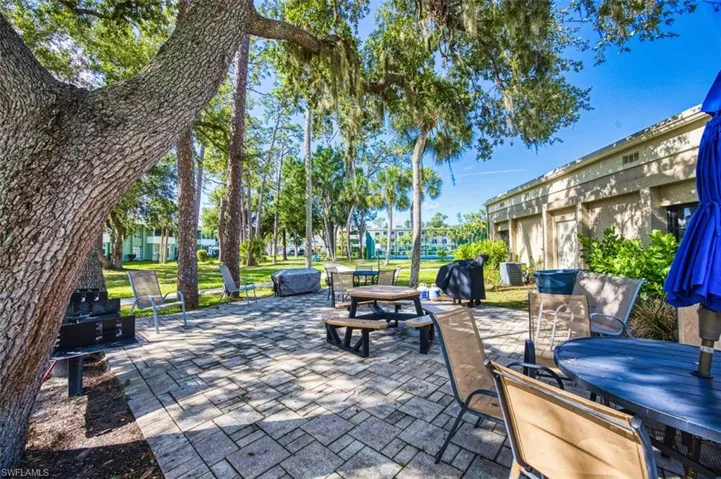 View of patio with outdoor dining area and a grill
