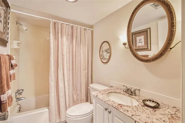 Full bathroom with shower / bath combo and vanity