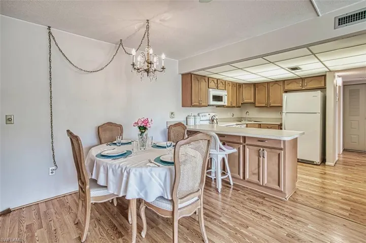 Dining room featuring laminate floors and a chandelier