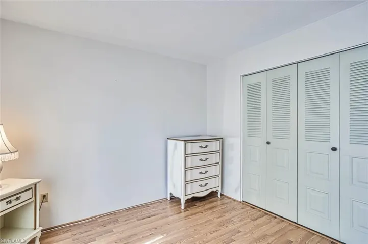 Bedroom with a closet and light wood-style flooring
