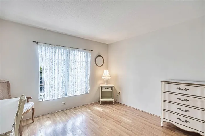 Second bedroom featuring laminate floors and a textured ceiling. All you need is the bed.