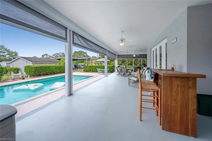 View of pool with ceiling fan