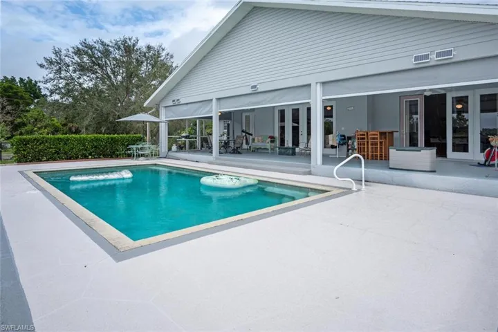 View of pool featuring french doors and a patio area