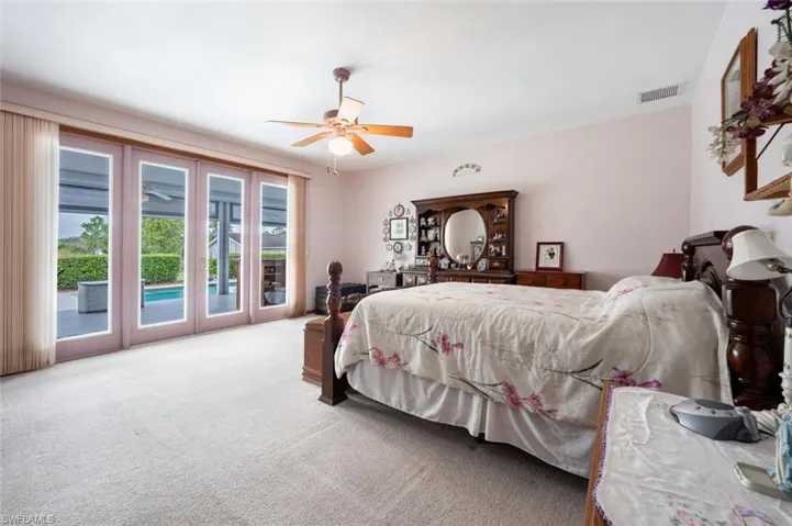 Carpeted bedroom with access to exterior and ceiling fan