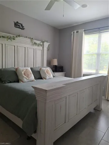 Bedroom featuring a ceiling fan, recessed lighting, and a window with blinds and drapes