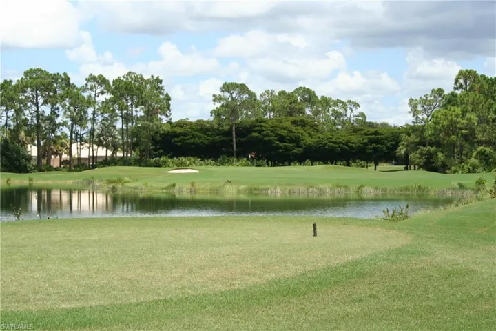 Expansive golf course frontage featuring a water hazard, sand trap, and manicured green