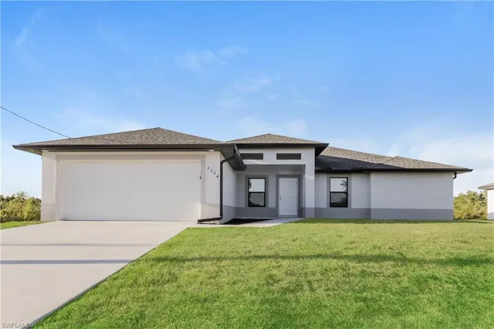 Prairie-style house with a garage and a front lawn