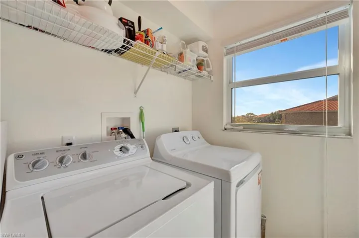 Clothes washing area featuring washing machine and clothes dryer