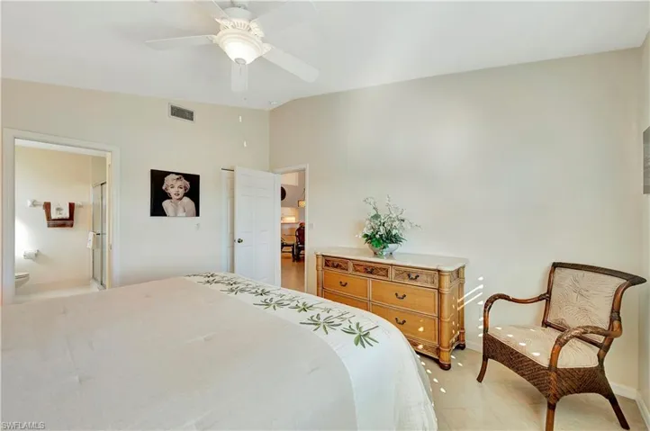 Bedroom with ensuite bath and ceiling fan