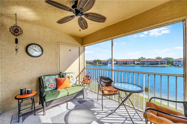 Sunroom / solarium featuring ceiling fan, a water view, and a healthy amount of sunlight