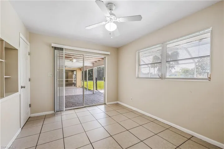 Tiled spare room with ceiling fan