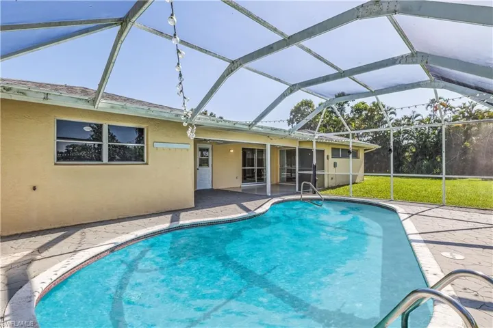 View of pool featuring a patio area and a lanai