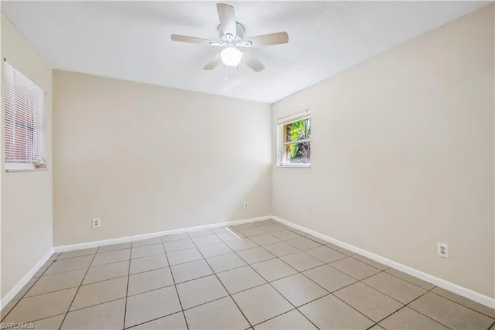 Spare room featuring ceiling fan and light tile patterned flooring