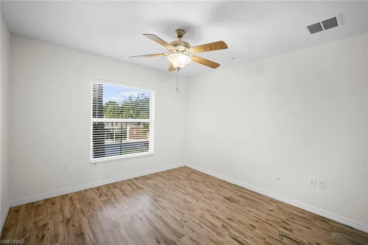 Unfurnished room featuring light wood-type flooring and ceiling fan