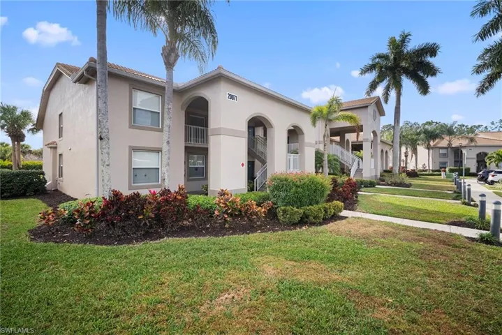 Mediterranean / spanish home with stucco siding and a front lawn