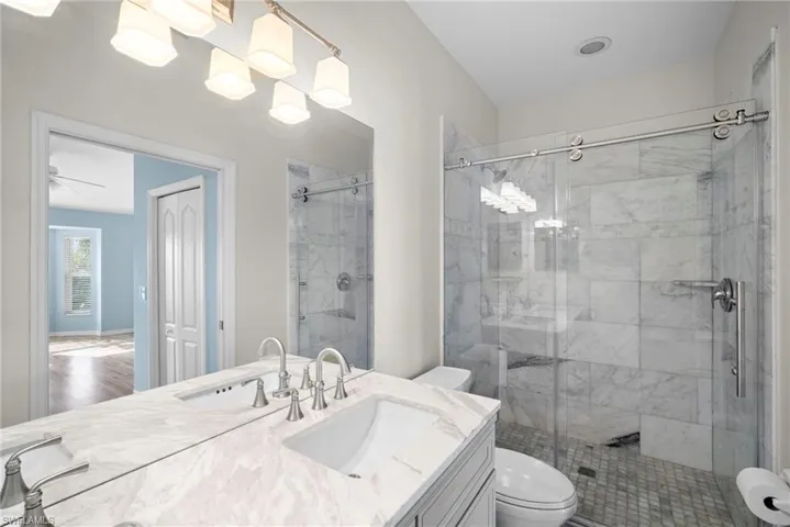 Full bath with vanity and a stall shower