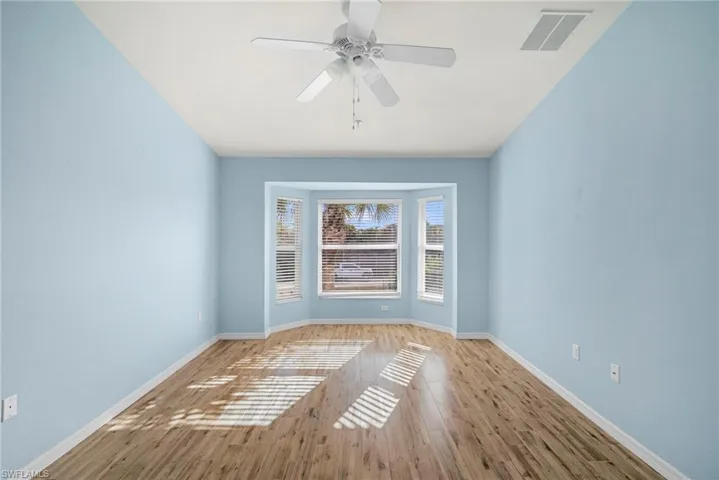 Spare room featuring light wood finished floors and ceiling fan